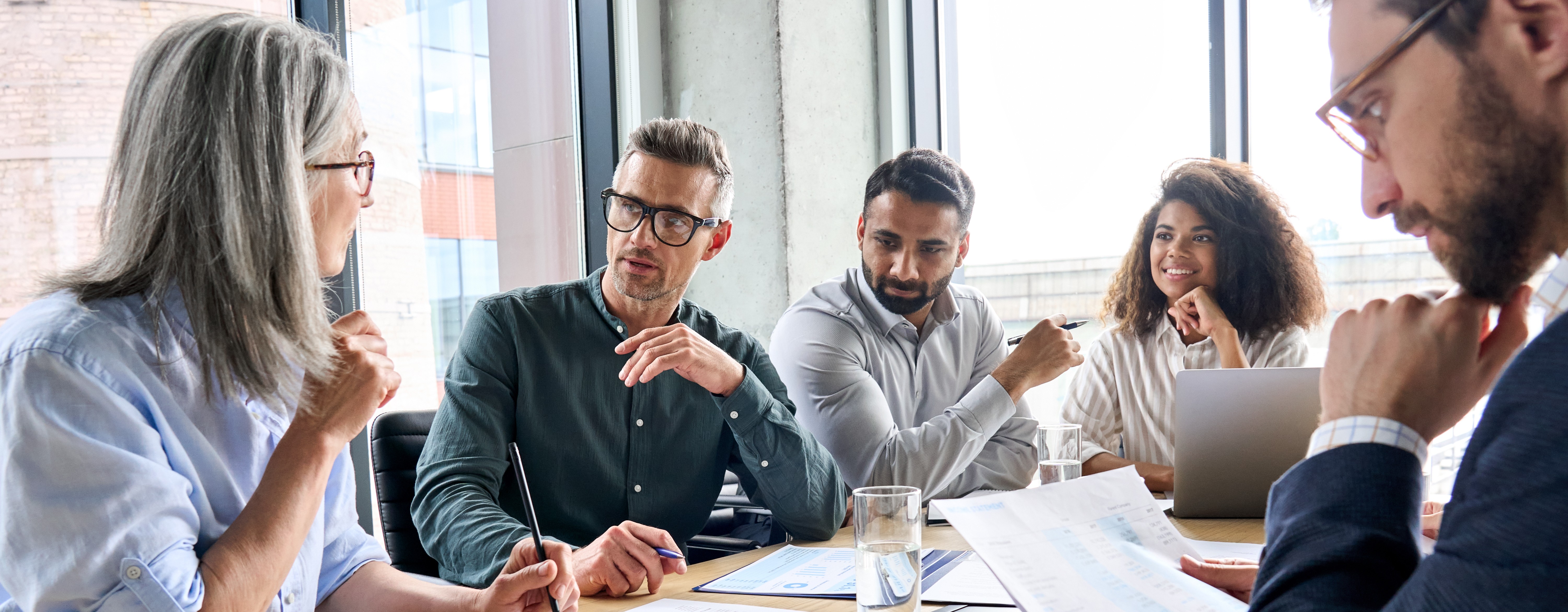 Professionals engaged in a discussion around a conference table