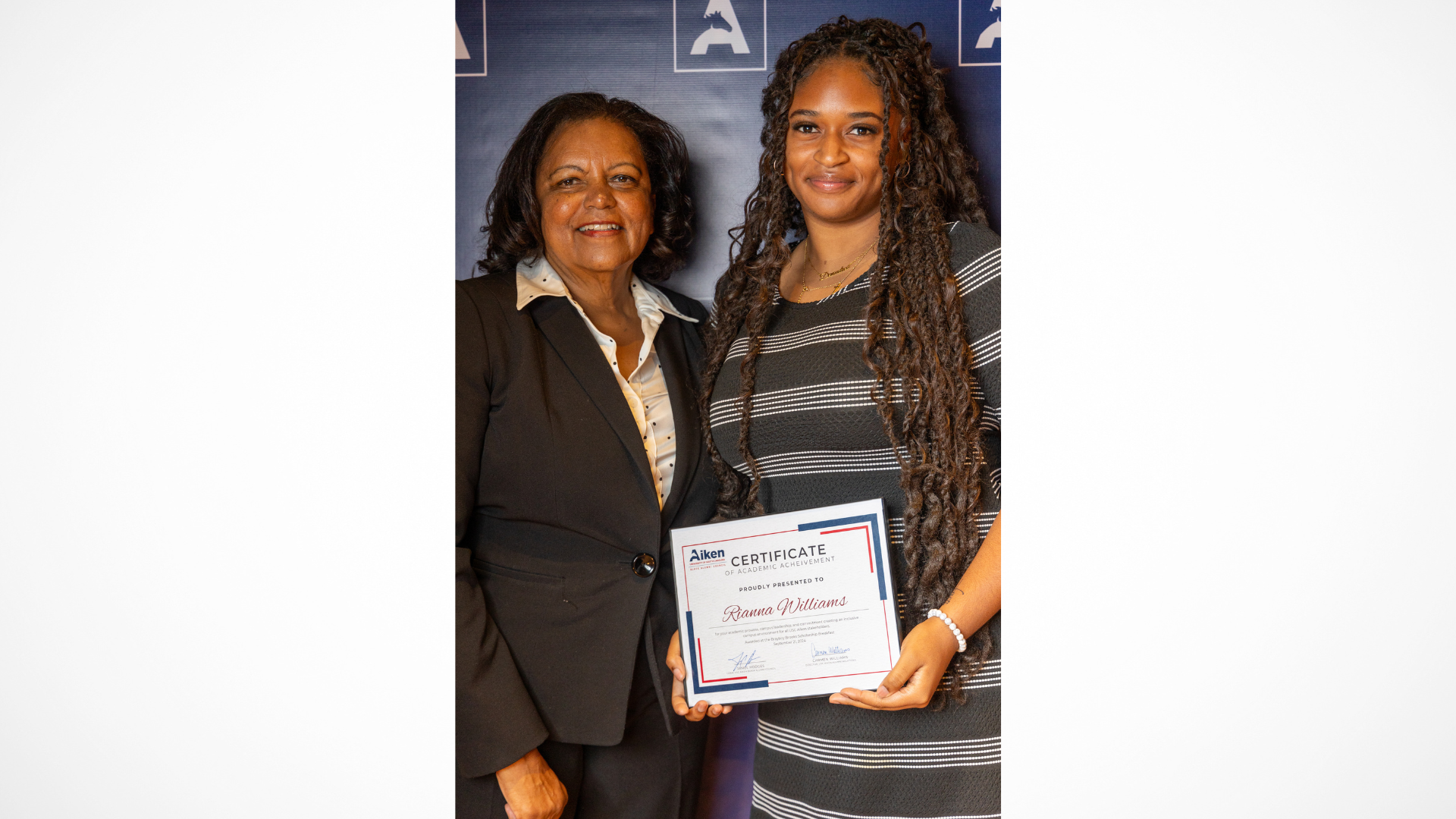 Barbara Alicia Brayboy Brooks (left) and Rianna Williams (right) stand together as Williams receives the scholarship honoring Brooks.