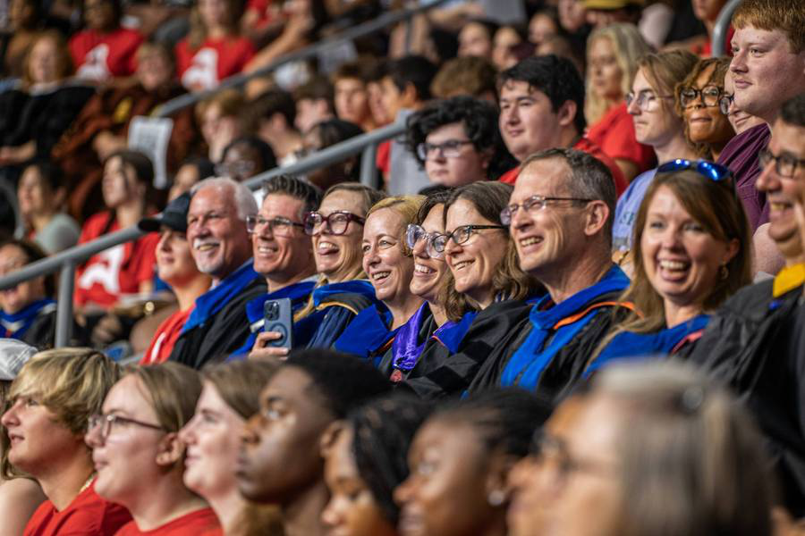 Faculty and staff sit alongside the Class of 2028 during the annual Freshman Convocation Event.