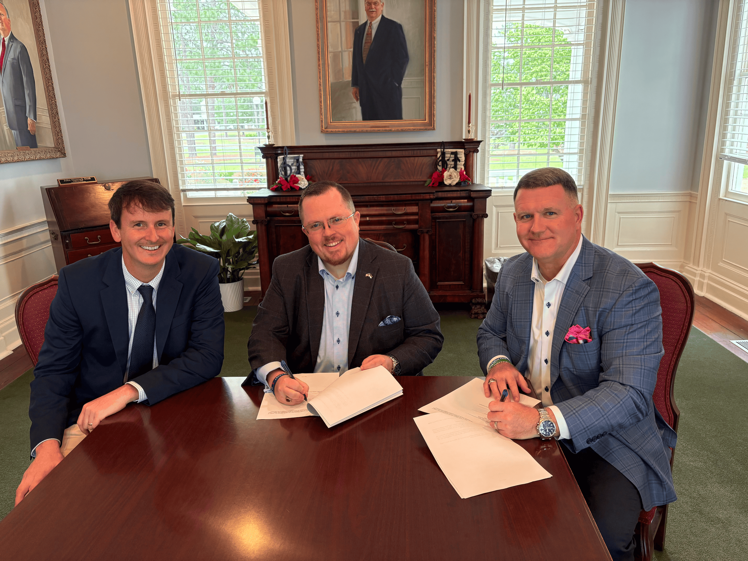 USCA alumni Jason Crane (center) and Gerry Owen (right) sit alongside Wesley Brown, USCA's major gift officer, as they establish the Jason K. Crane and Gerry L. Owen Endowed Business Scholarship.