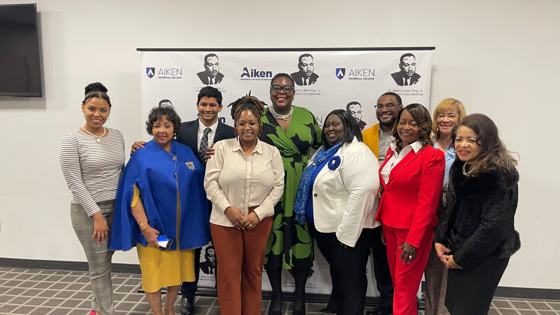 USCA and Aiken Tech's planning committee stand alongside South Carolina Democratic Chair and event emcee, Christale Spain.