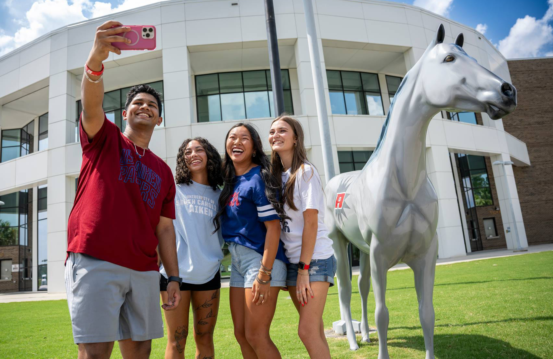 Group of students pose for selfie.